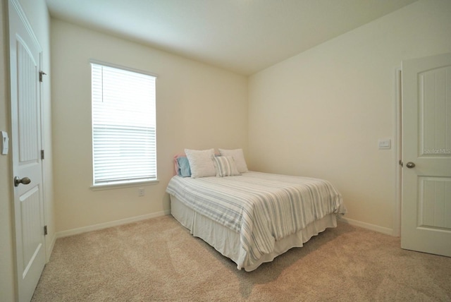 bedroom featuring light colored carpet