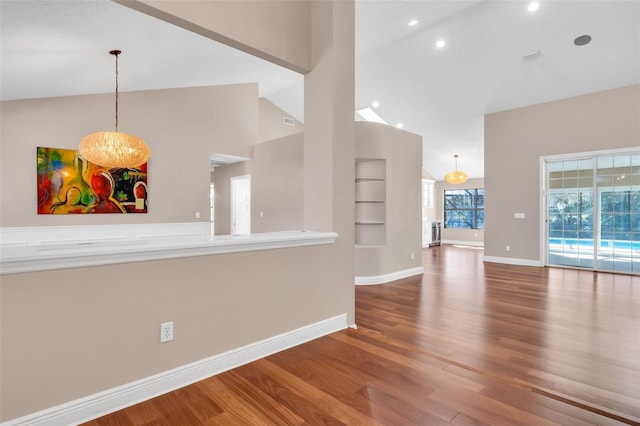 interior space with hardwood / wood-style floors, built in features, and high vaulted ceiling