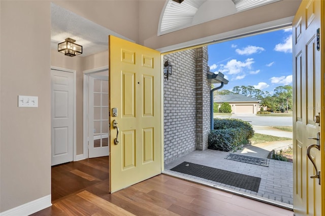 foyer with hardwood / wood-style floors and a textured ceiling