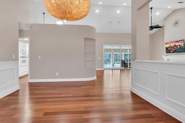 interior space with hardwood / wood-style flooring, high vaulted ceiling, and ceiling fan