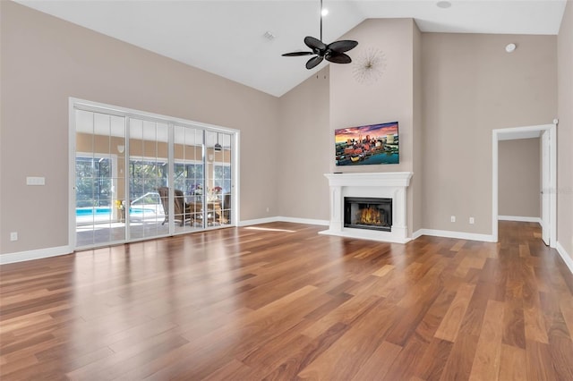 unfurnished living room featuring hardwood / wood-style floors, high vaulted ceiling, and ceiling fan