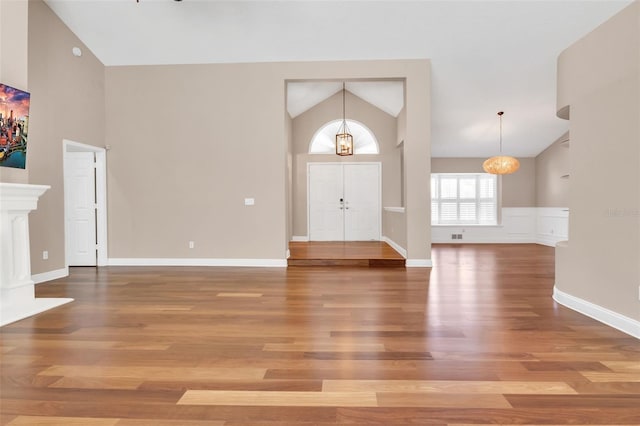 foyer featuring hardwood / wood-style flooring and high vaulted ceiling