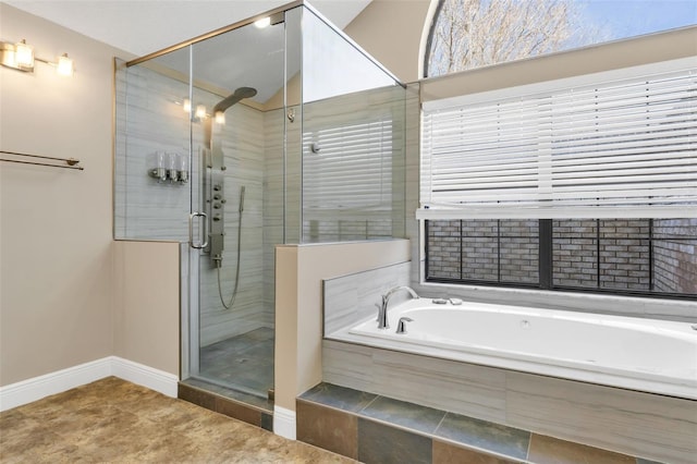 bathroom featuring shower with separate bathtub