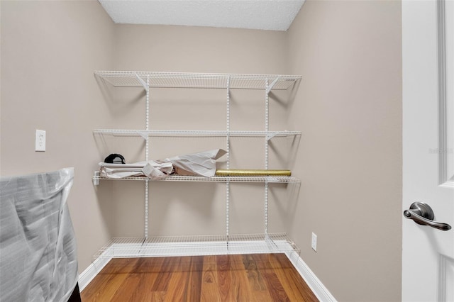 walk in closet featuring hardwood / wood-style flooring