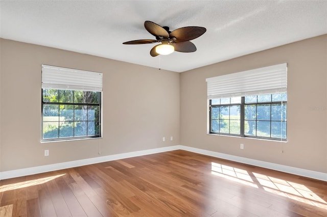 unfurnished room featuring wood-type flooring, a textured ceiling, and ceiling fan