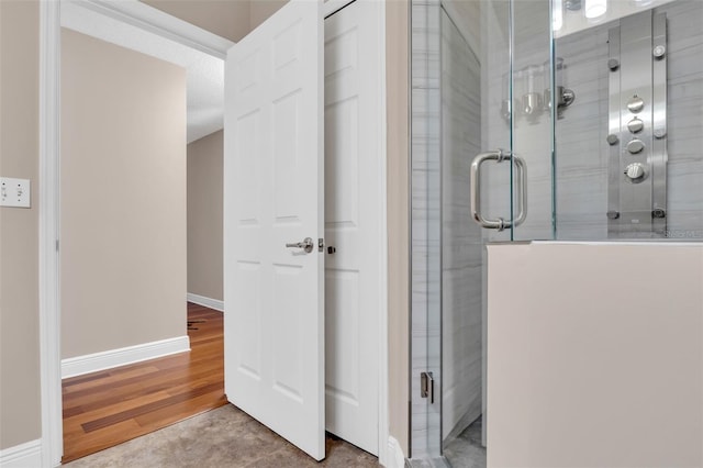 bathroom with hardwood / wood-style floors and walk in shower