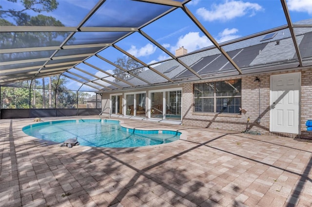 view of pool featuring a patio and glass enclosure