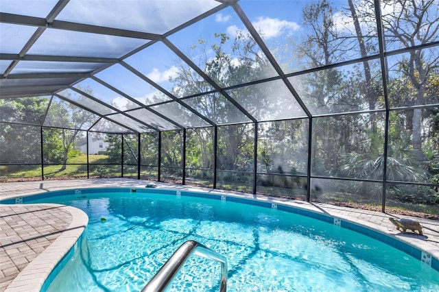 view of swimming pool with a patio and glass enclosure