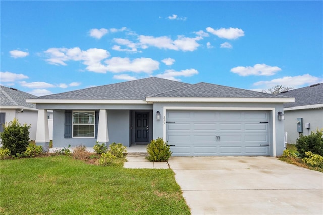 single story home with a garage and a front lawn