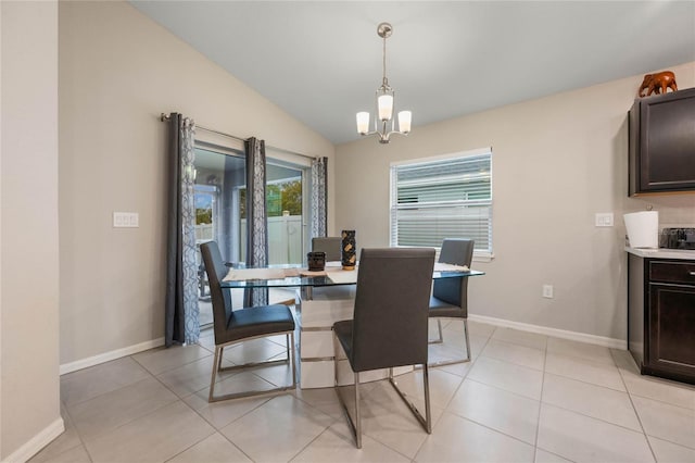 dining area featuring light tile patterned flooring, vaulted ceiling, and a notable chandelier