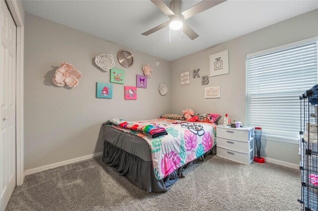 bedroom with multiple windows, carpet floors, ceiling fan, and a closet