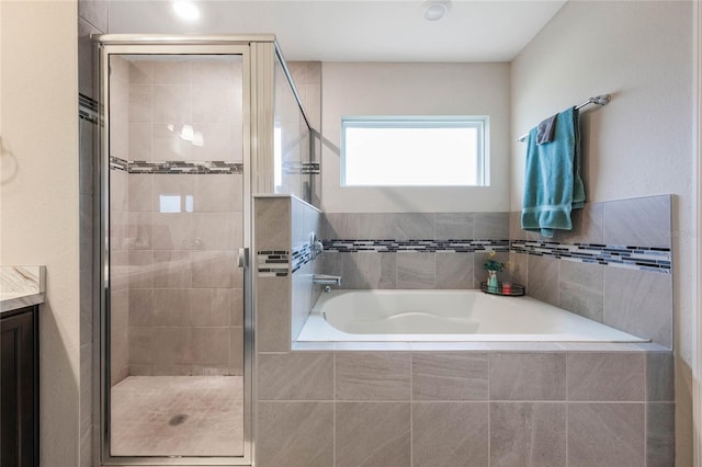 bathroom featuring vanity and shower with separate bathtub