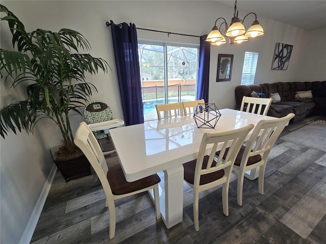 dining space with dark wood-type flooring and a chandelier