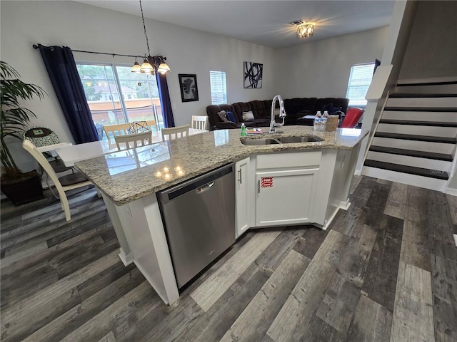 kitchen with a kitchen island with sink, sink, stainless steel dishwasher, and white cabinets