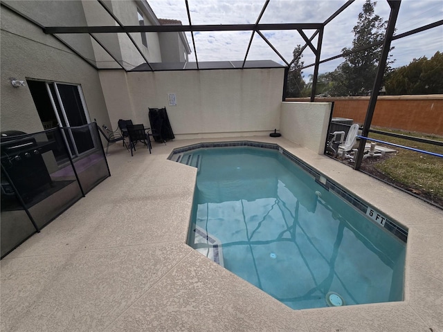 view of pool with a lanai and a patio area