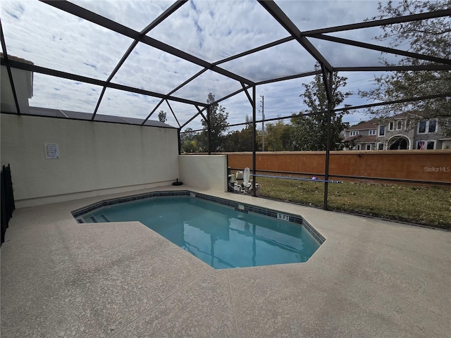 view of swimming pool featuring a lanai and a patio