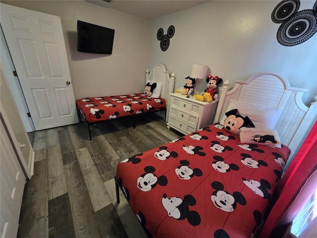 bedroom with dark hardwood / wood-style flooring