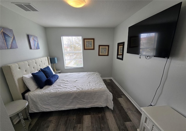 bedroom featuring dark hardwood / wood-style flooring