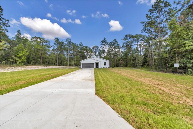 9095 SW 125th Ter, Dunnellon, FL 34432 - view of front of property with a garage, a front lawn, and concrete driveway