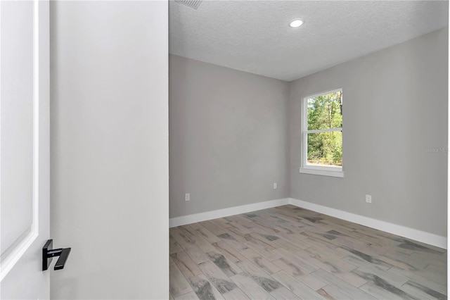 9095 SW 125th Ter, Dunnellon, FL 34432 - unfurnished room featuring a textured ceiling, baseboards, wood finished floors, and recessed lighting