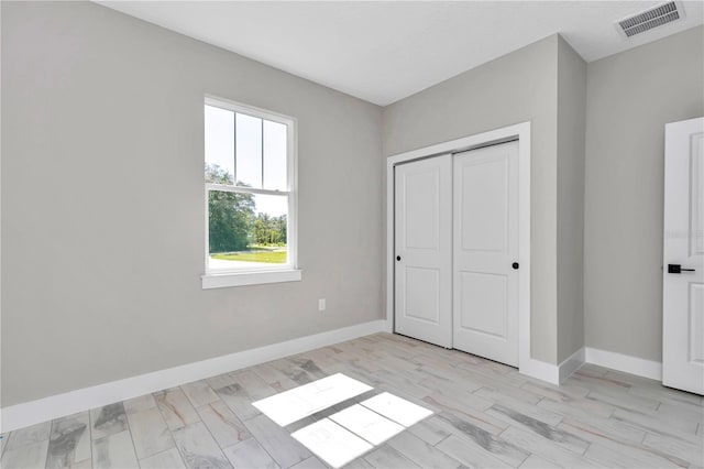 9095 SW 125th Ter, Dunnellon, FL 34432 - unfurnished bedroom with baseboards and a closet