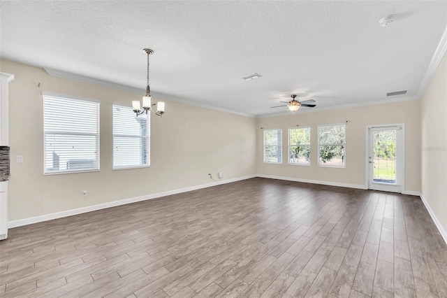 unfurnished living room featuring crown molding, ceiling fan with notable chandelier, a textured ceiling, and light wood-type flooring