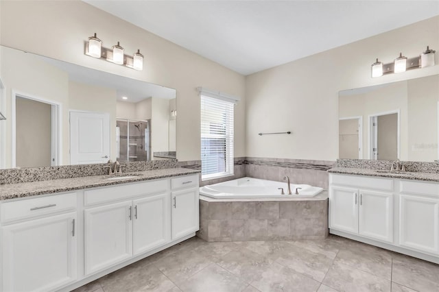 bathroom with tile patterned floors, vanity, and independent shower and bath