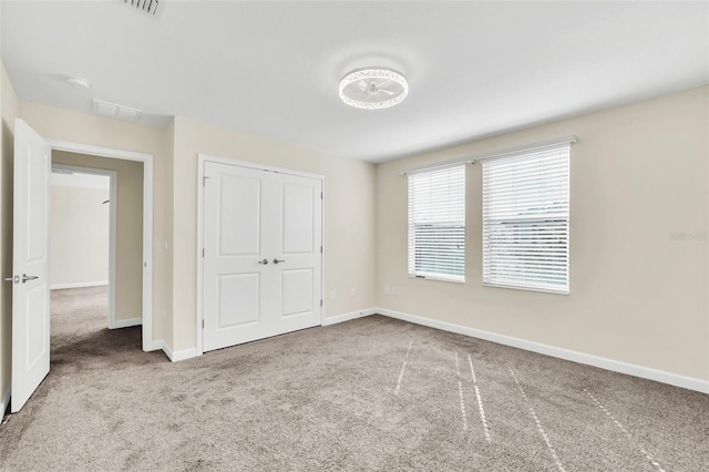 unfurnished bedroom featuring carpet floors and a closet