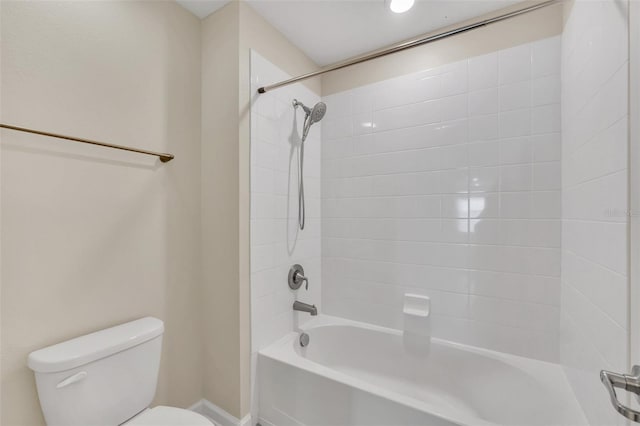 bathroom featuring tiled shower / bath and toilet