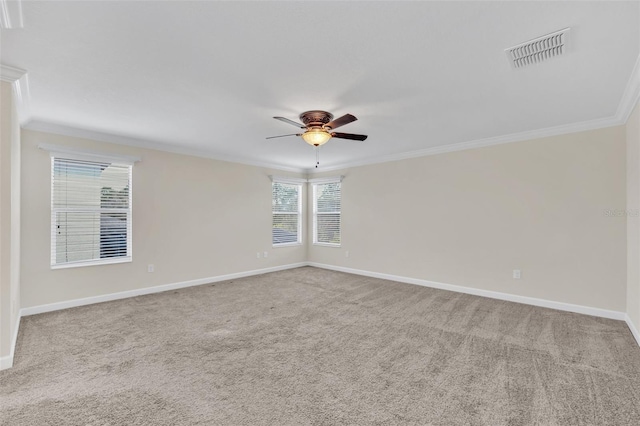 carpeted empty room with crown molding and ceiling fan