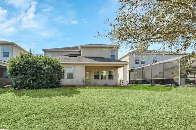 rear view of property with glass enclosure and a lawn