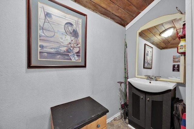 bathroom featuring wood ceiling, vanity, and vaulted ceiling