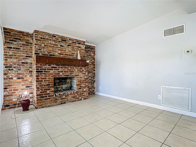 unfurnished living room featuring a fireplace and light tile patterned floors