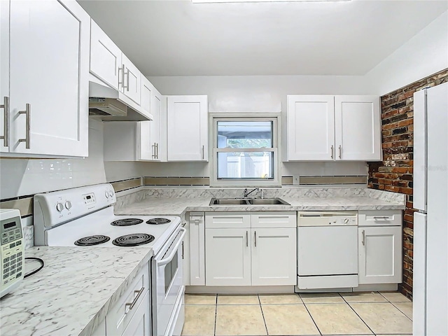 kitchen featuring white cabinetry, sink, white appliances, and brick wall