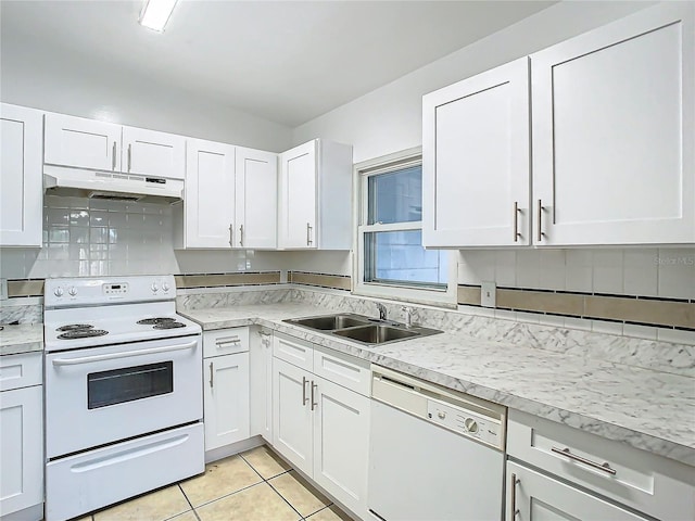 kitchen featuring white appliances, light tile patterned floors, sink, and white cabinets