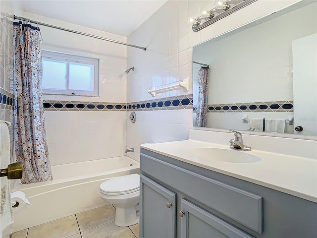 full bathroom with tile walls, vanity, shower / tub combo, toilet, and tile patterned floors