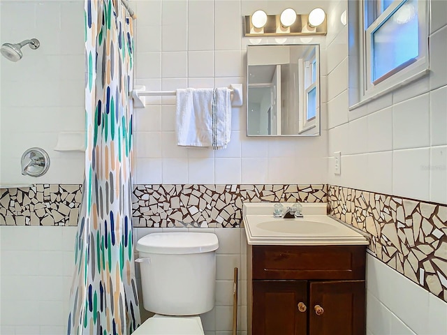 bathroom with tile walls, vanity, toilet, and walk in shower