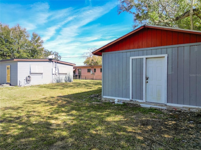 view of outdoor structure featuring a lawn