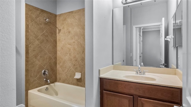 bathroom featuring vanity and tiled shower / bath combo