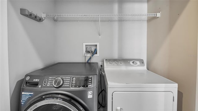 clothes washing area with separate washer and dryer