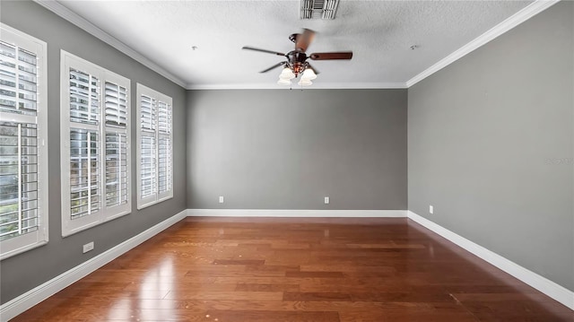 empty room featuring crown molding, dark wood-type flooring, ceiling fan, and a textured ceiling