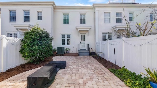 back of property with a patio and central air condition unit