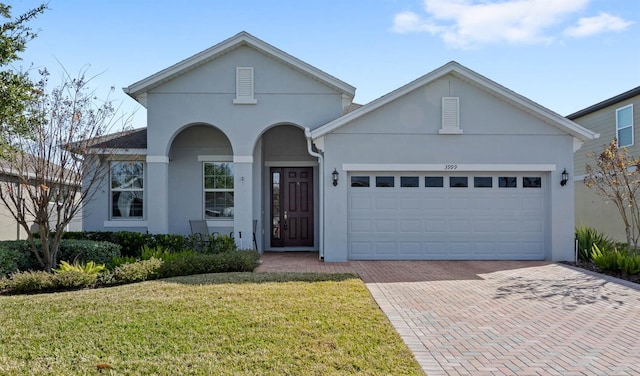 view of front of home featuring a garage and a front lawn