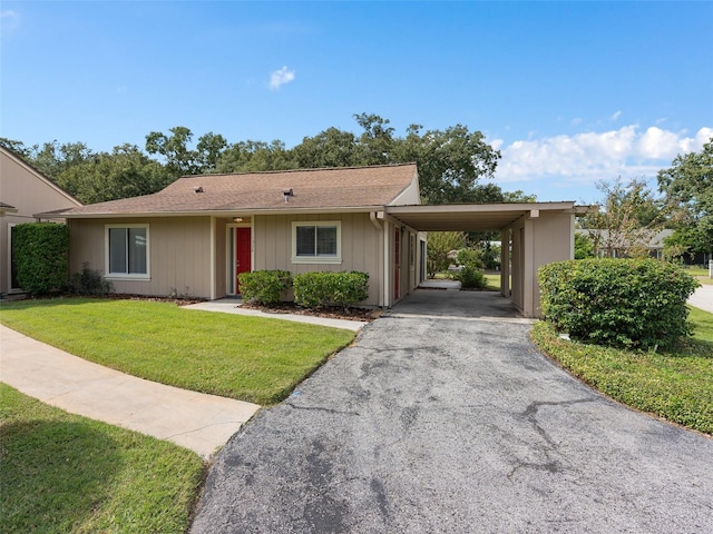 single story home featuring a front lawn and a carport