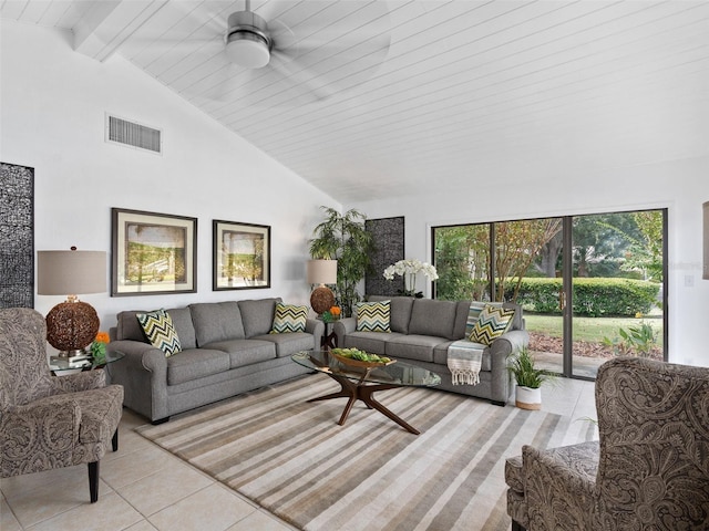 tiled living room featuring beam ceiling and high vaulted ceiling