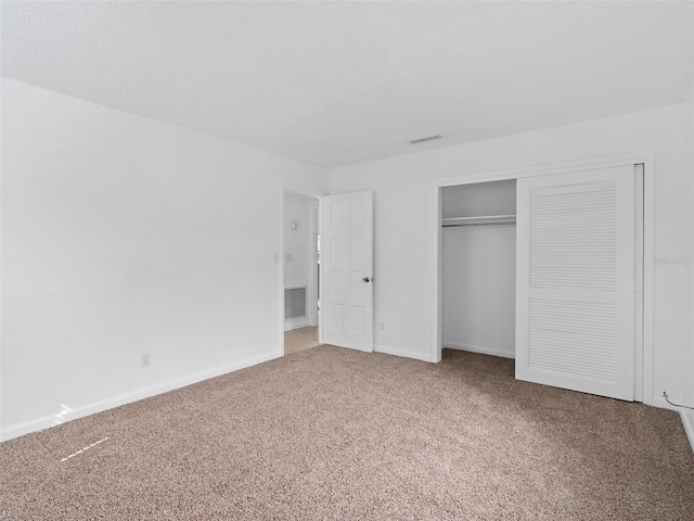 unfurnished bedroom with carpet floors and a closet