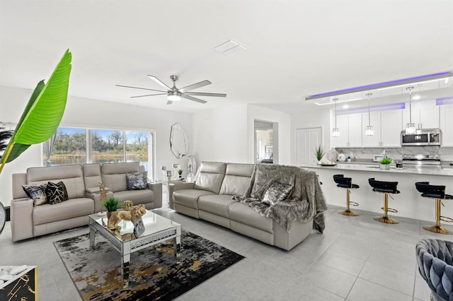 tiled living room with ceiling fan