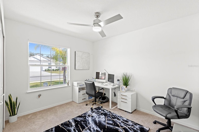 office space with light carpet and ceiling fan