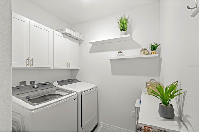 laundry area featuring cabinets and washer and dryer