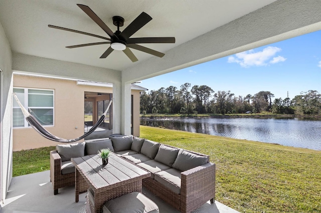 view of patio featuring an outdoor living space, ceiling fan, and a water view